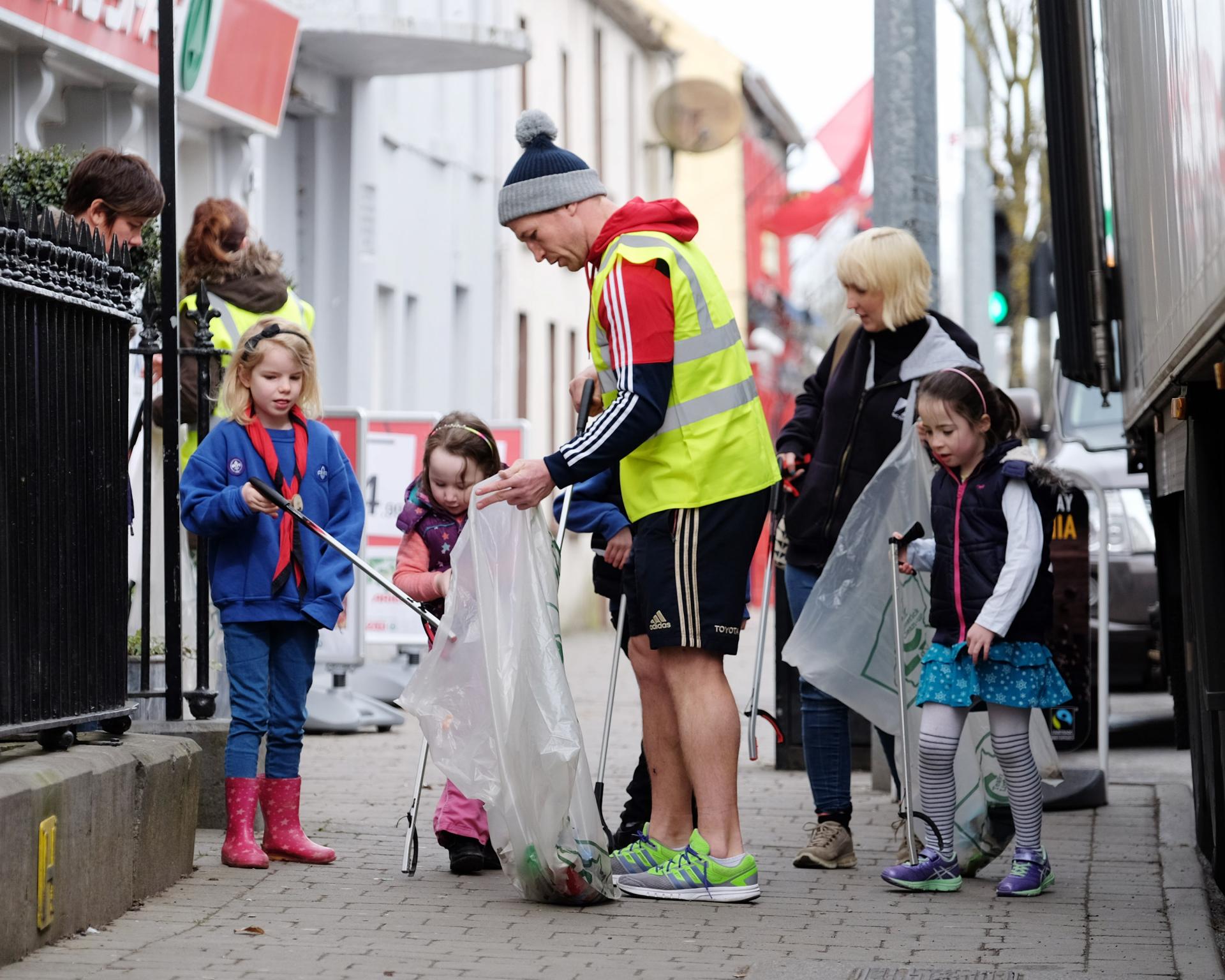 Jerry Flannery helps children clean up the streets in Bruff